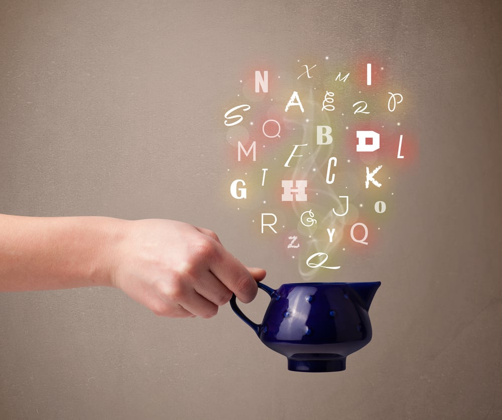 Tea pot with colorful letters, close up Tea pot with colorful letters, close up